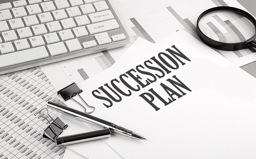 SUCCESSION PLAN text on a paper with chart and keyboard, business succession plan concept