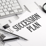 SUCCESSION PLAN text on a paper with chart and keyboard, business succession plan concept