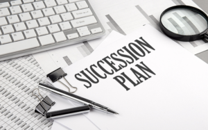 SUCCESSION PLAN text on a paper with chart and keyboard, business succession plan concept