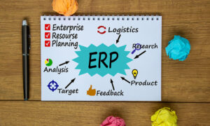 Notebook, pen and notes about ERP. Colored paper. Business concept.